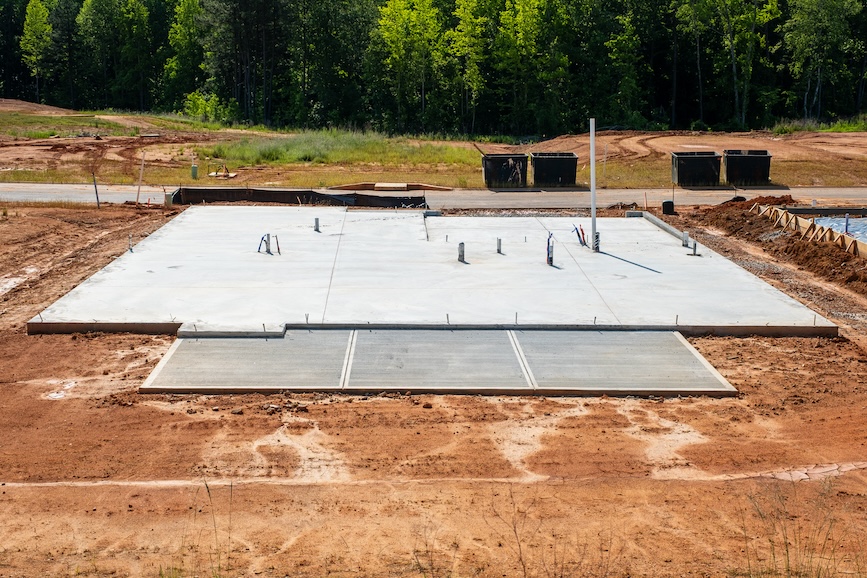 Slab-on-grade foundation with plumbing prep for residential house development